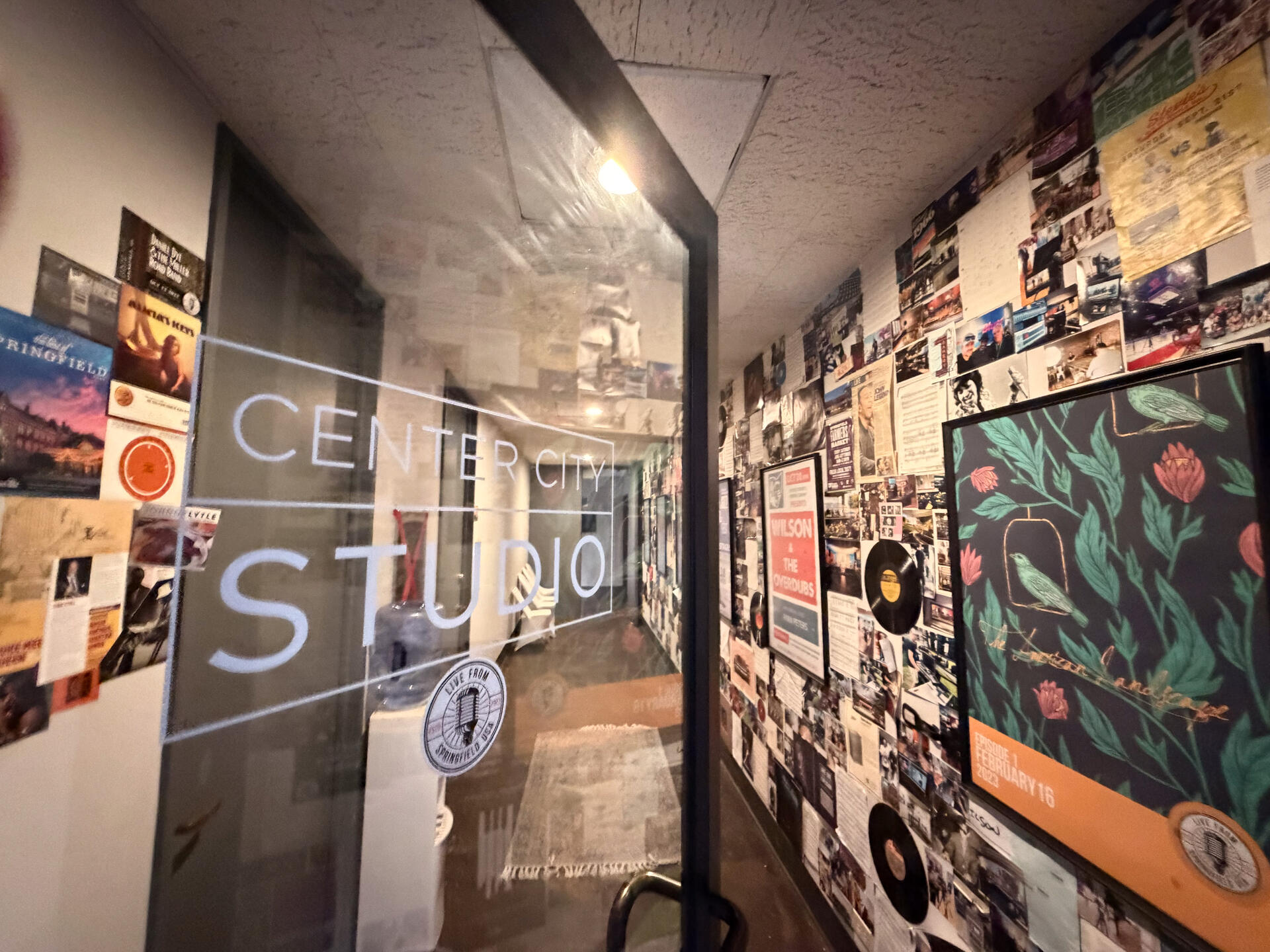 Studio hallway with wall of posters and vinyl records