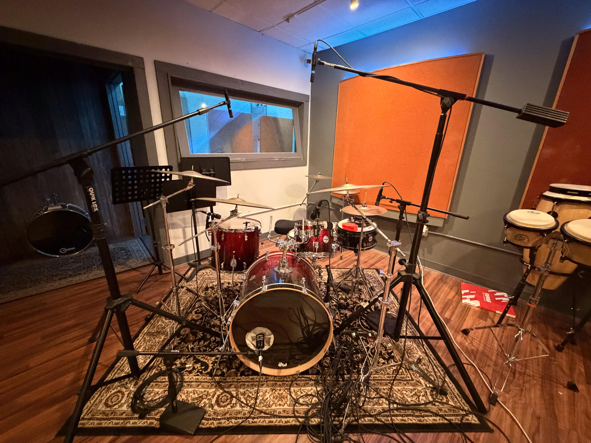 Drum kit setup with microphones in the live room
