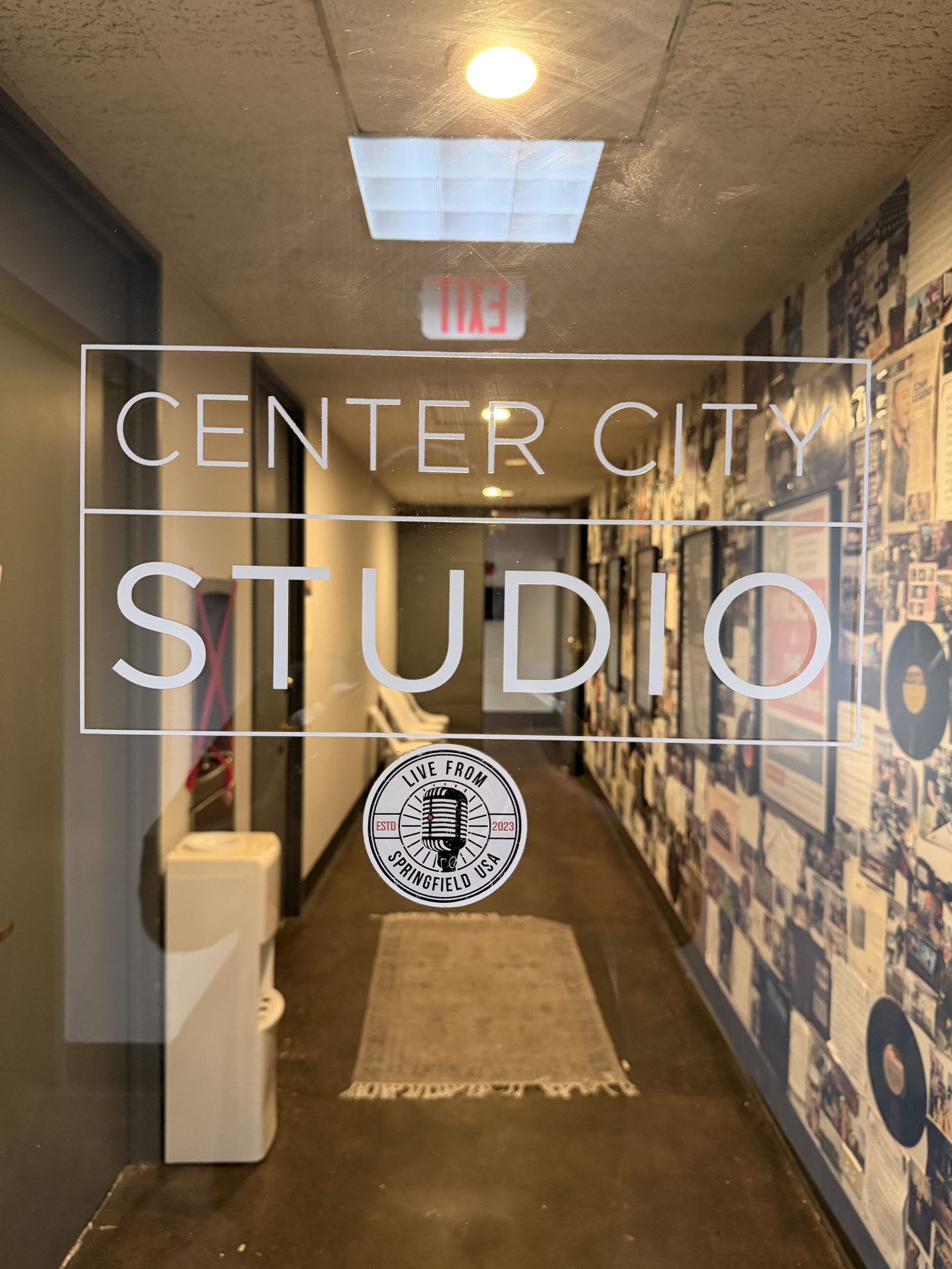 Center City Studio glass entrance with LUSA branding and album cover ceiling art