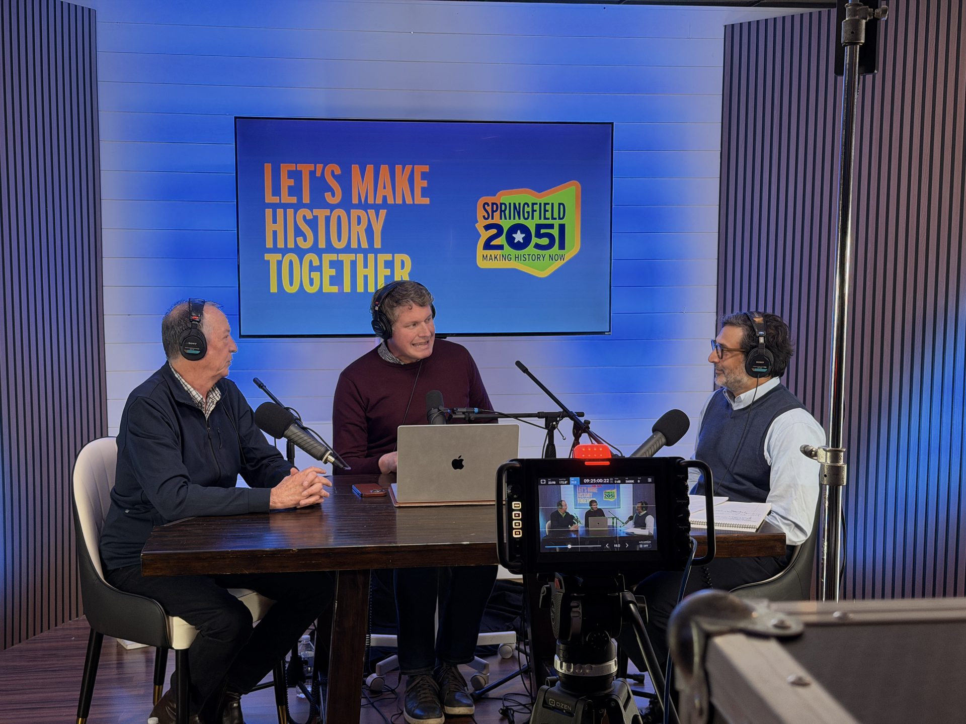 Three guests recording a podcast episode with Springfield 2051 branding on screen